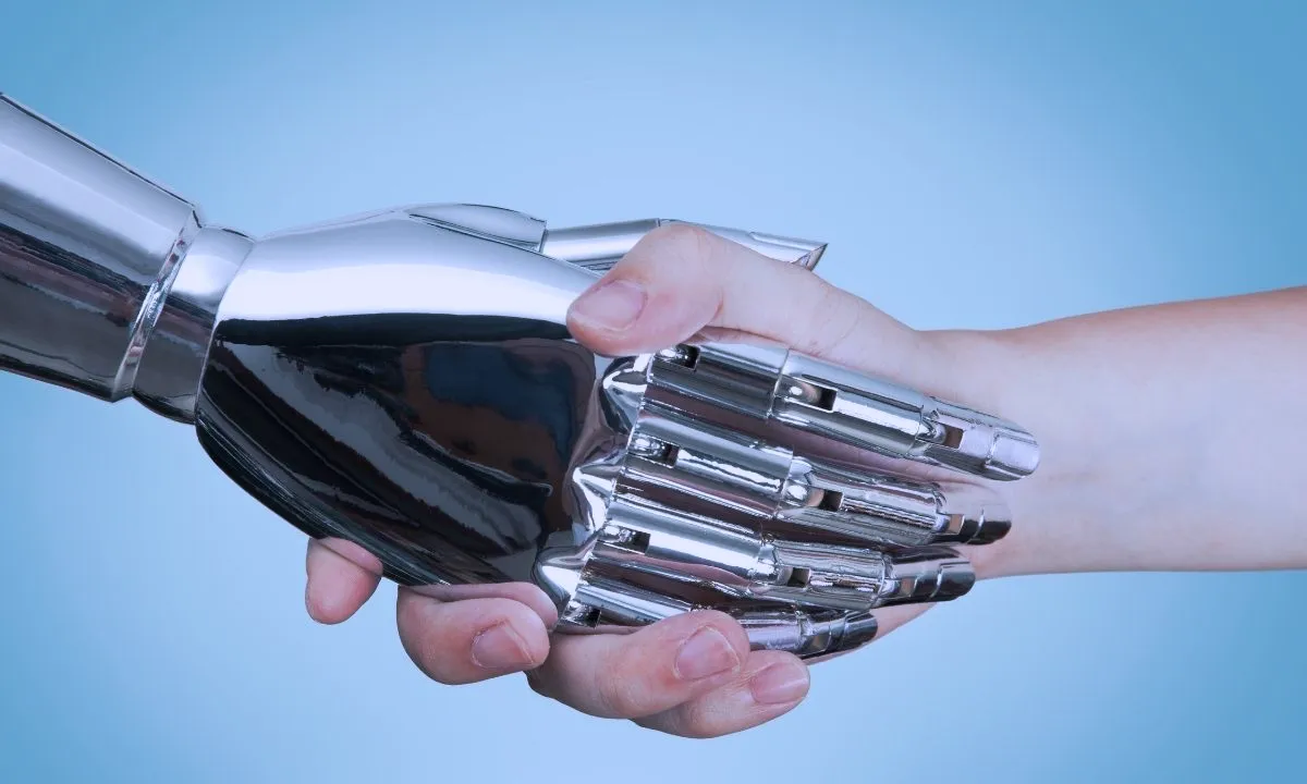 أفضل تطبيقات الذكاء الاصطناعي التي ستغير حياتك في 2025 5 مصافحة بين يد إنسان ويد روبوت تطبيقات الذكاء الاصطناعي